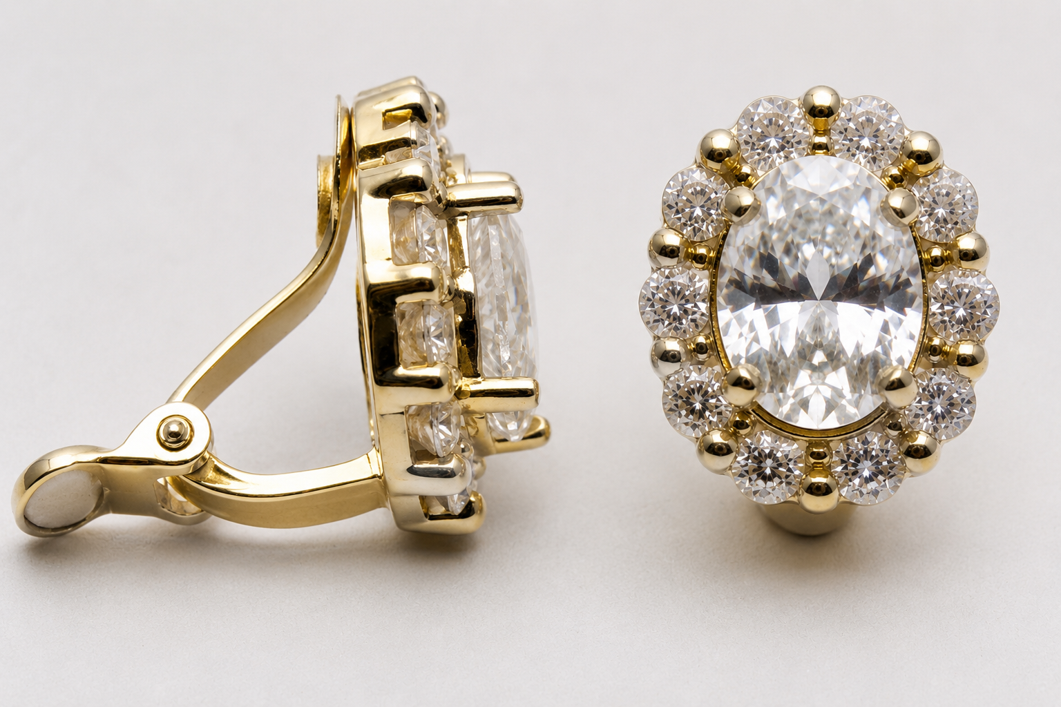  gold clip-on earrings featuring a large oval-cut clear gemstone surrounded by sparkling accent stones in a halo setting.
