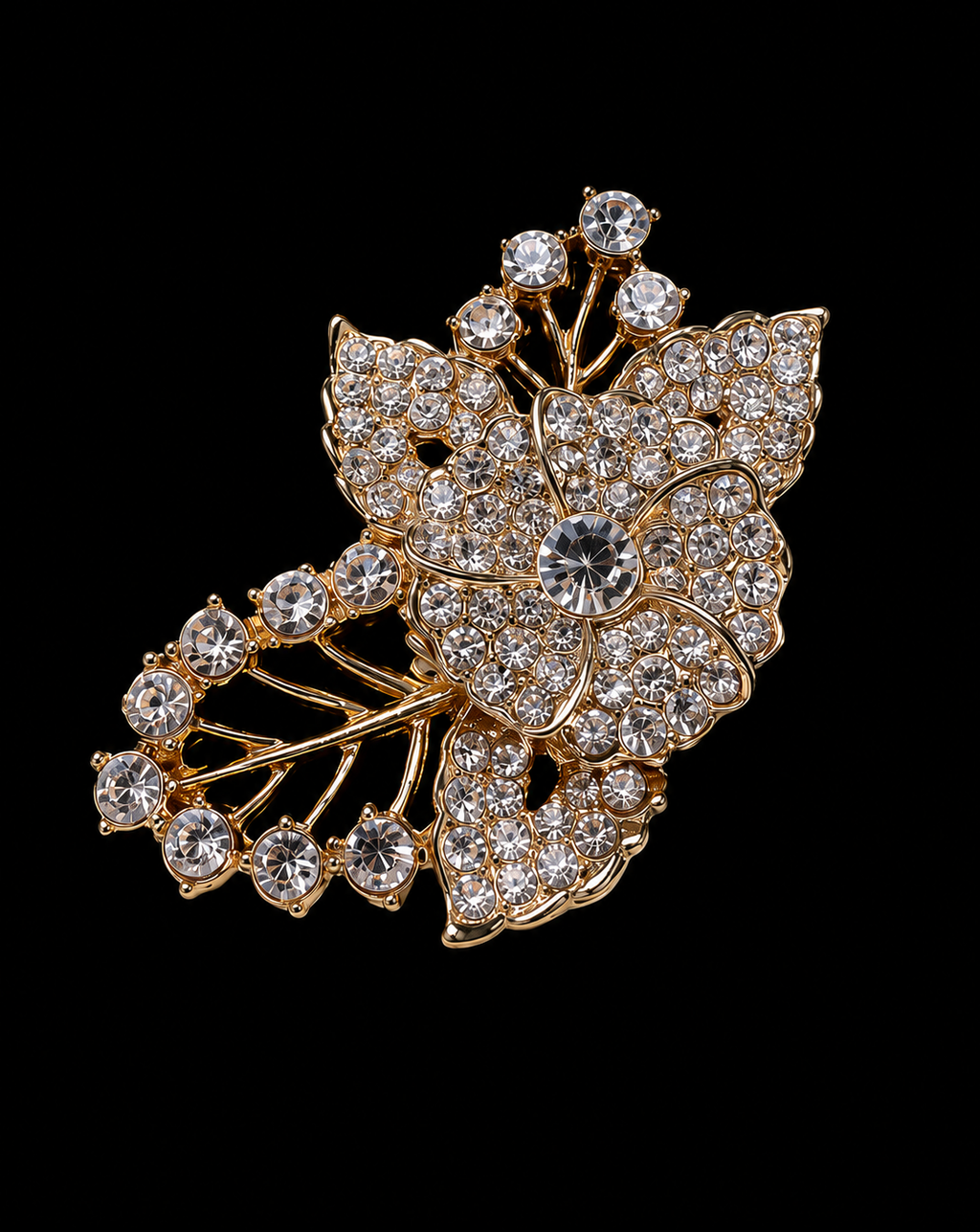 Gold brooch with crystal stones on a black background